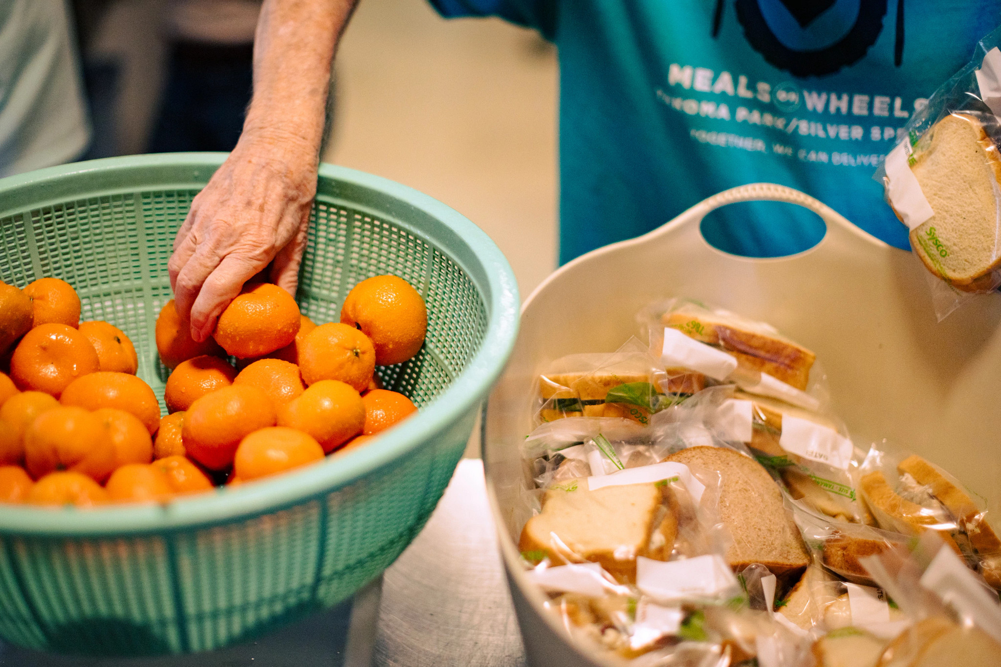 Volunteers and staff prepare the day’s fresh meals
