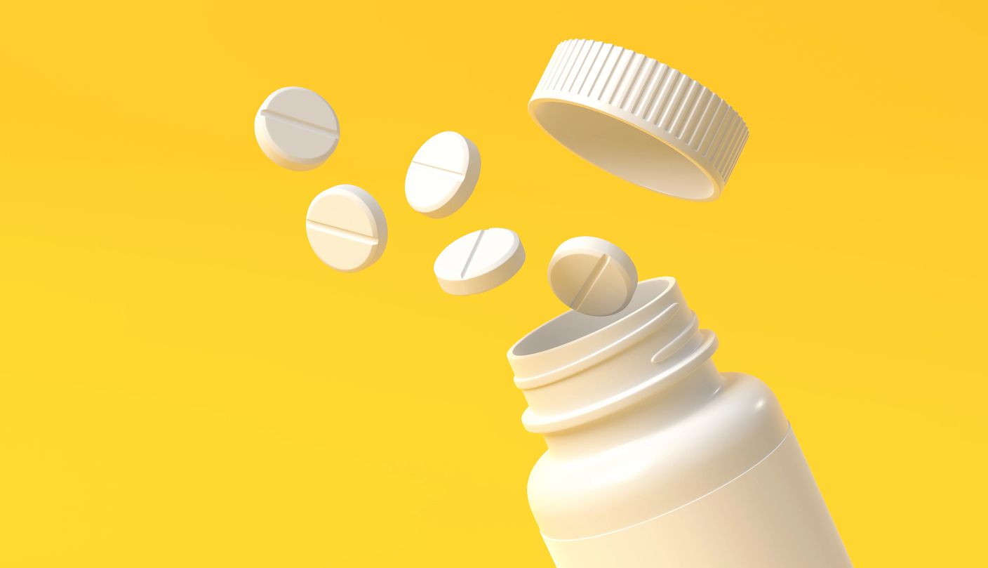 a bottle of pills on a yellow background