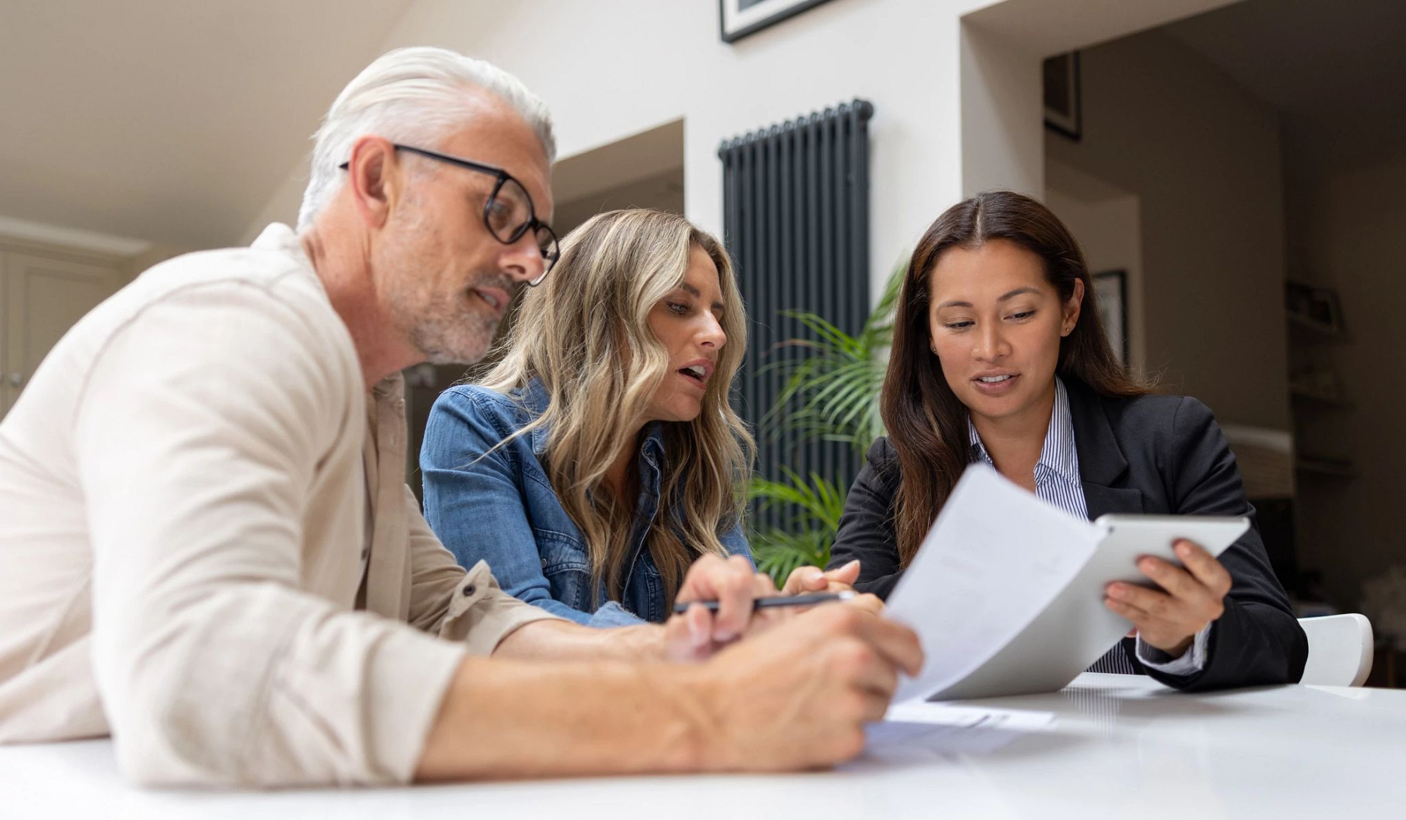 Financial advisor talking to a couple about finance concepts Financial advisor talking to a couple about finance concepts