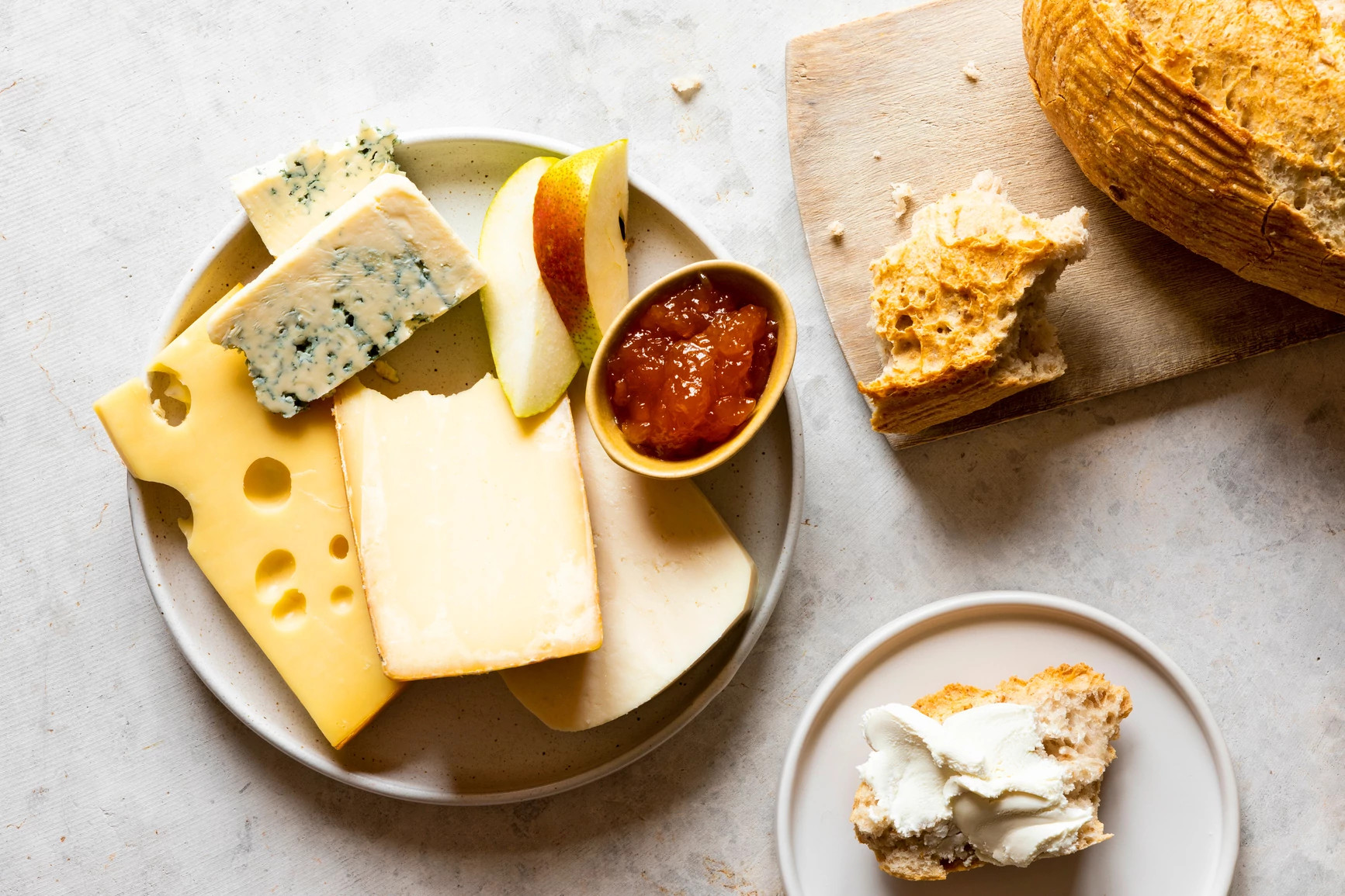 charcuterie board with fruit, cheese and bread