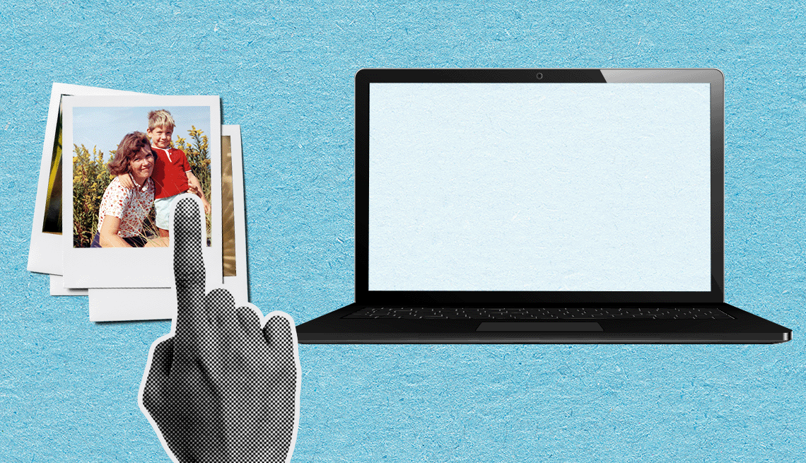 a finger swiping old photos onto a laptop