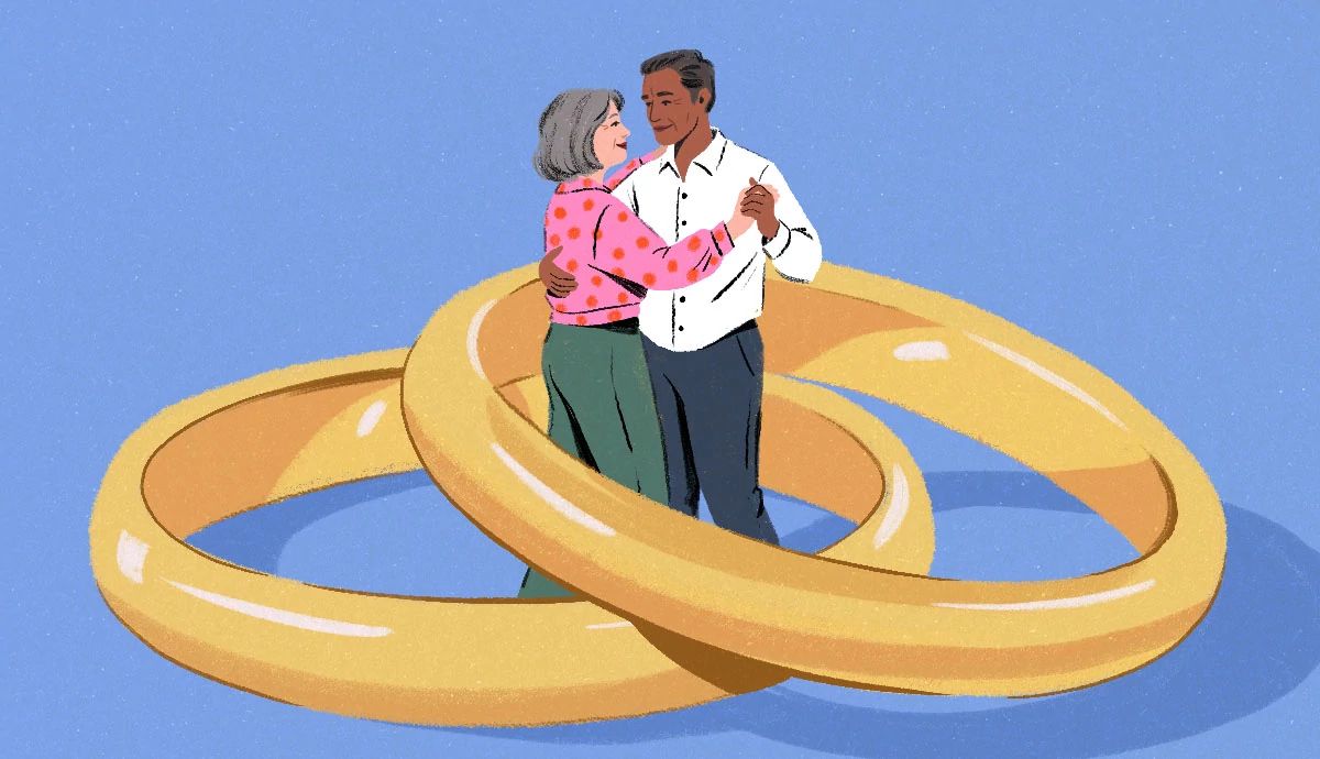 a couple dances in the middle of two giant entwined gold rings