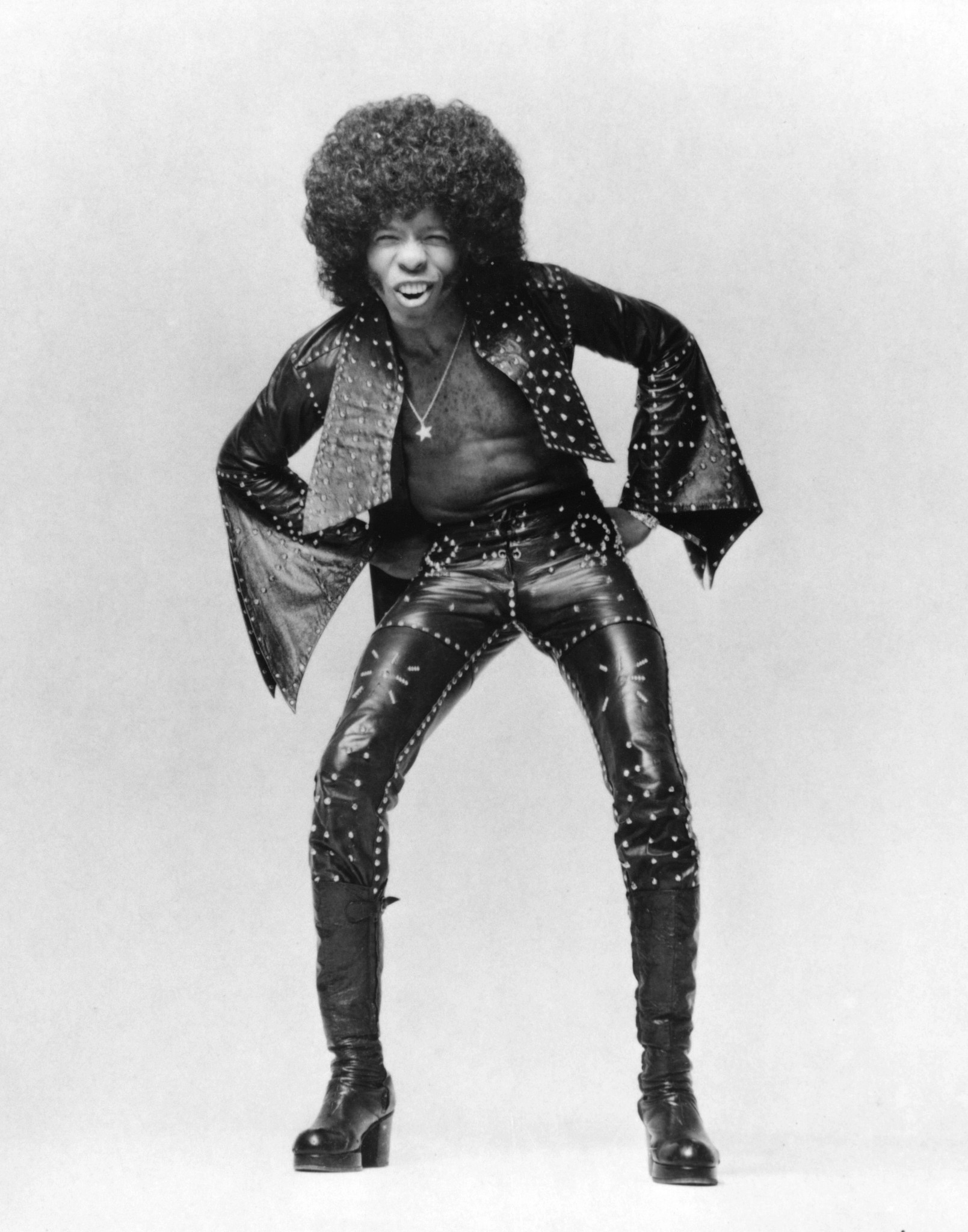 sly stone in a studded leather ensemble