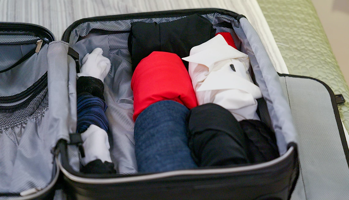 Clothes rolled up inside a carry on suitcase