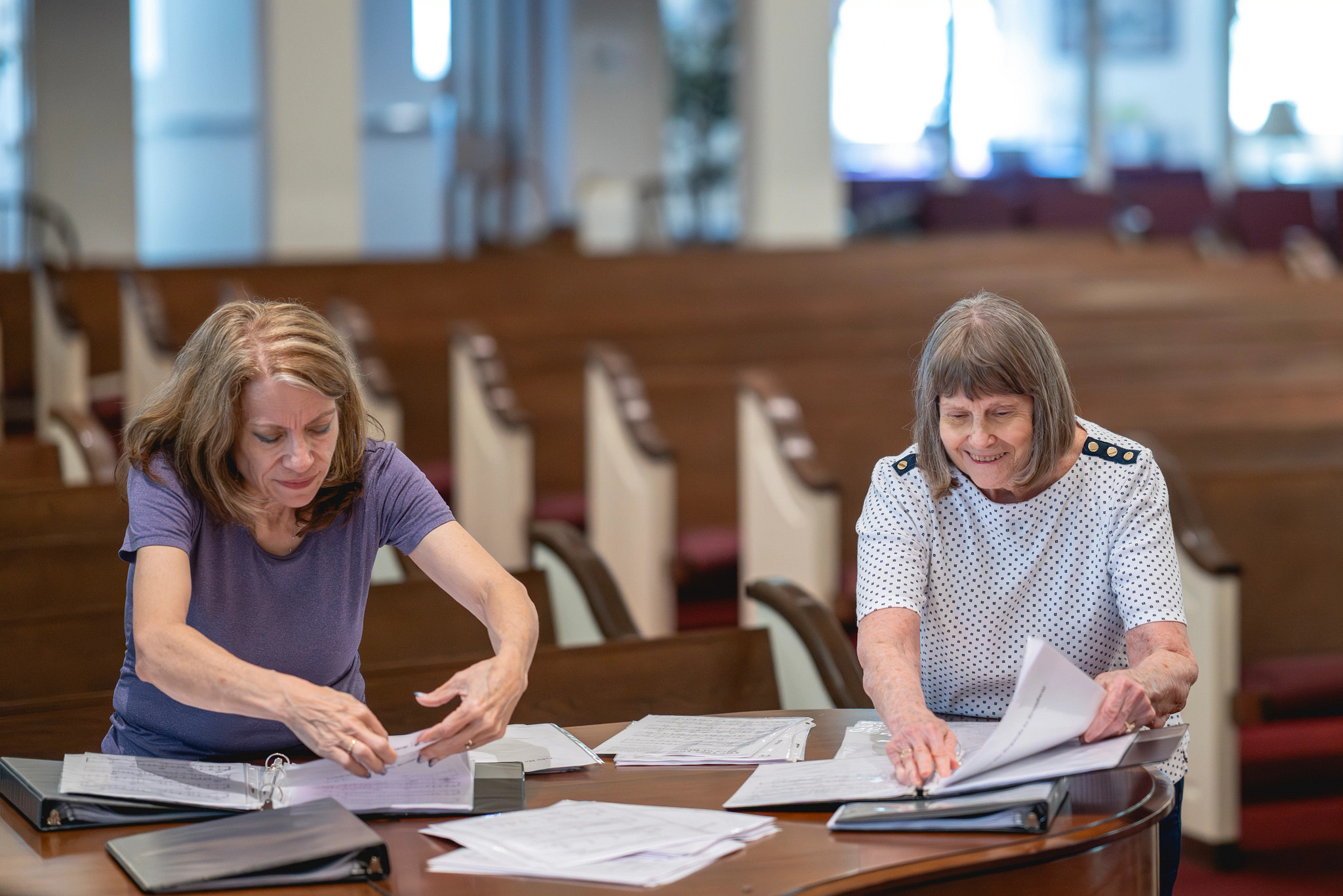 A photo shows Susan Dommer with Connie Young getting sheet music together for the Forgetful Friends Chorus