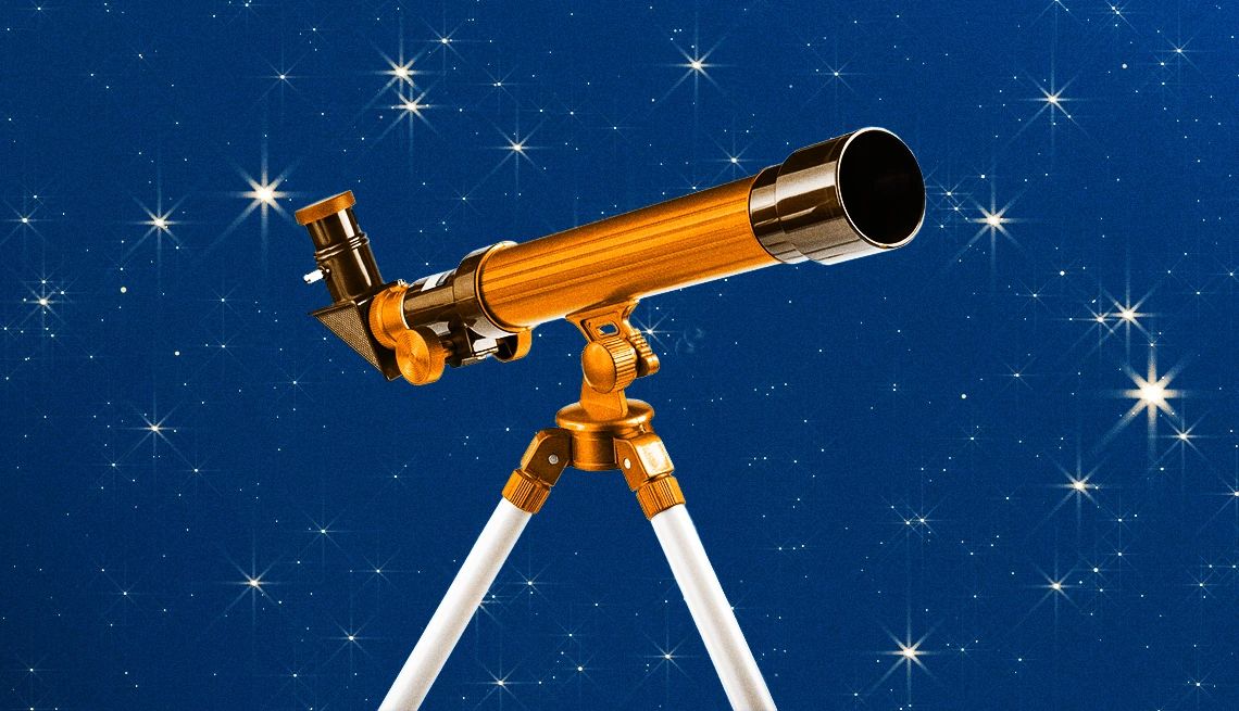 Telescope guided to stargazing A golden telescope, pointed towards a star-studded night sky.