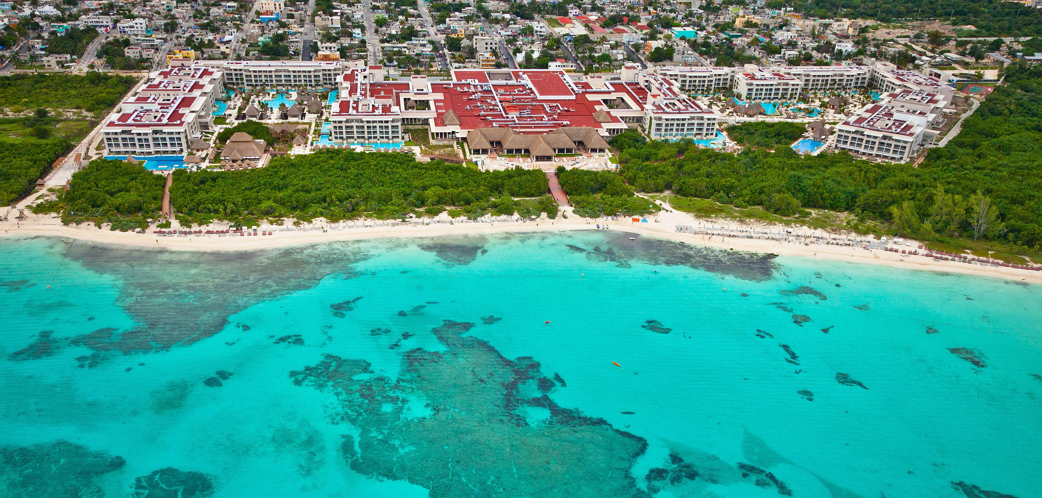 an aerial shot of a resort near the beach