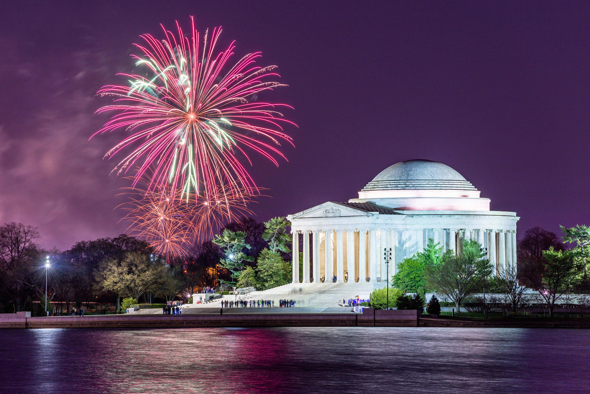 fireworks set off in the background of the jefferson memorial