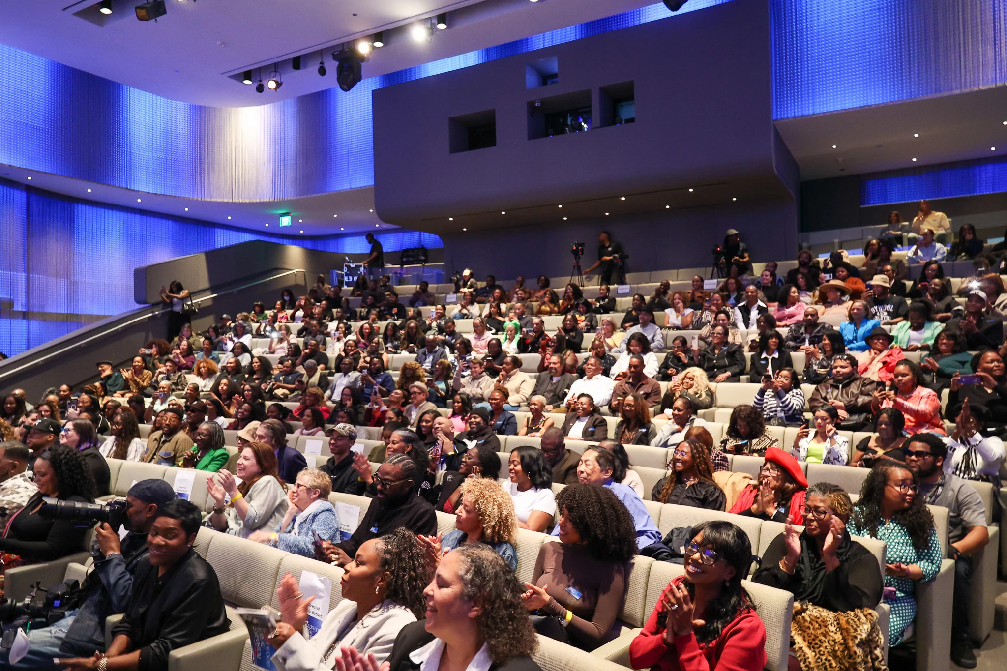 Audience members seated in an auditorium during the Ageless Ambition panel