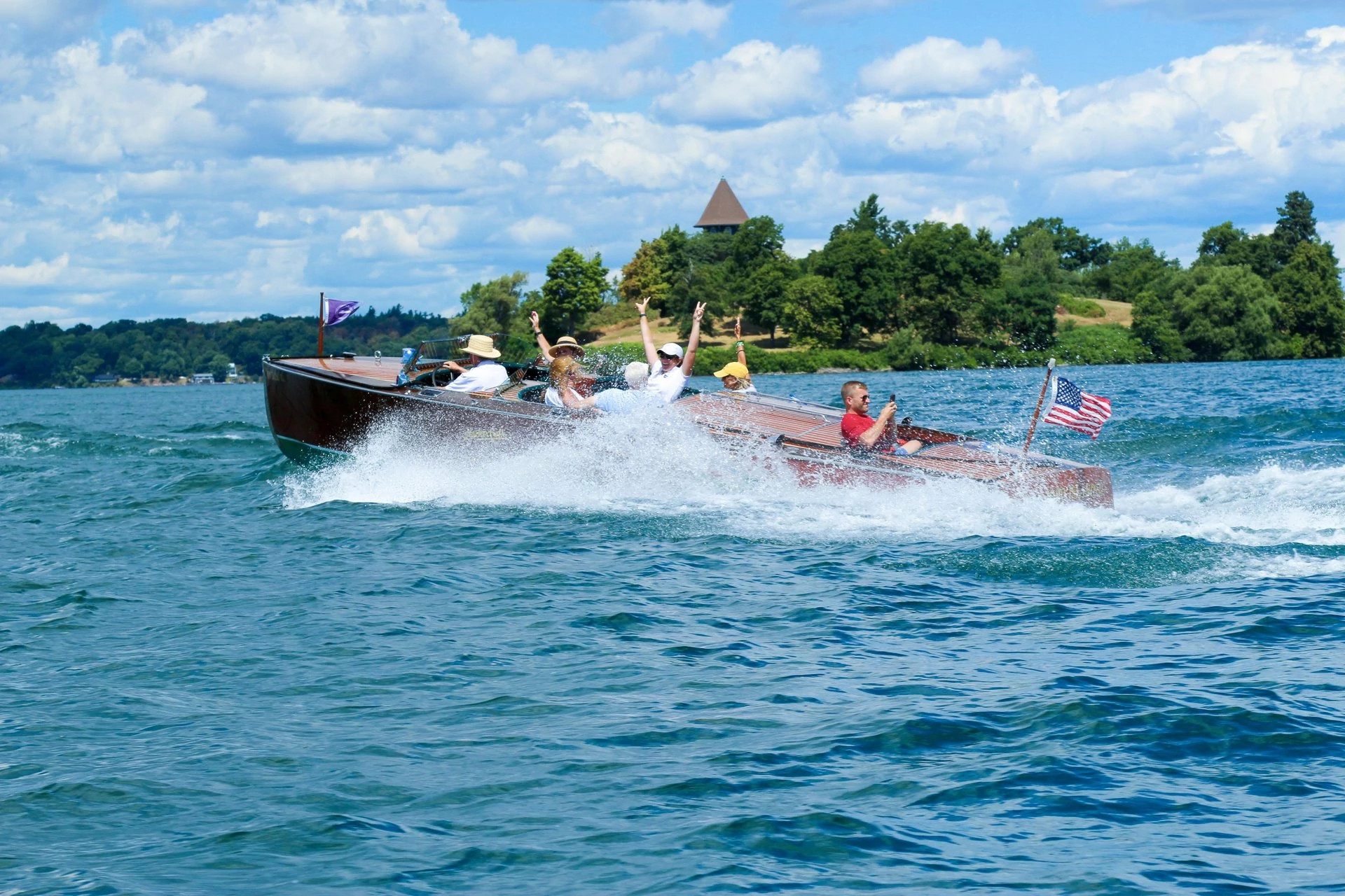people riding in a speedboat on a lake