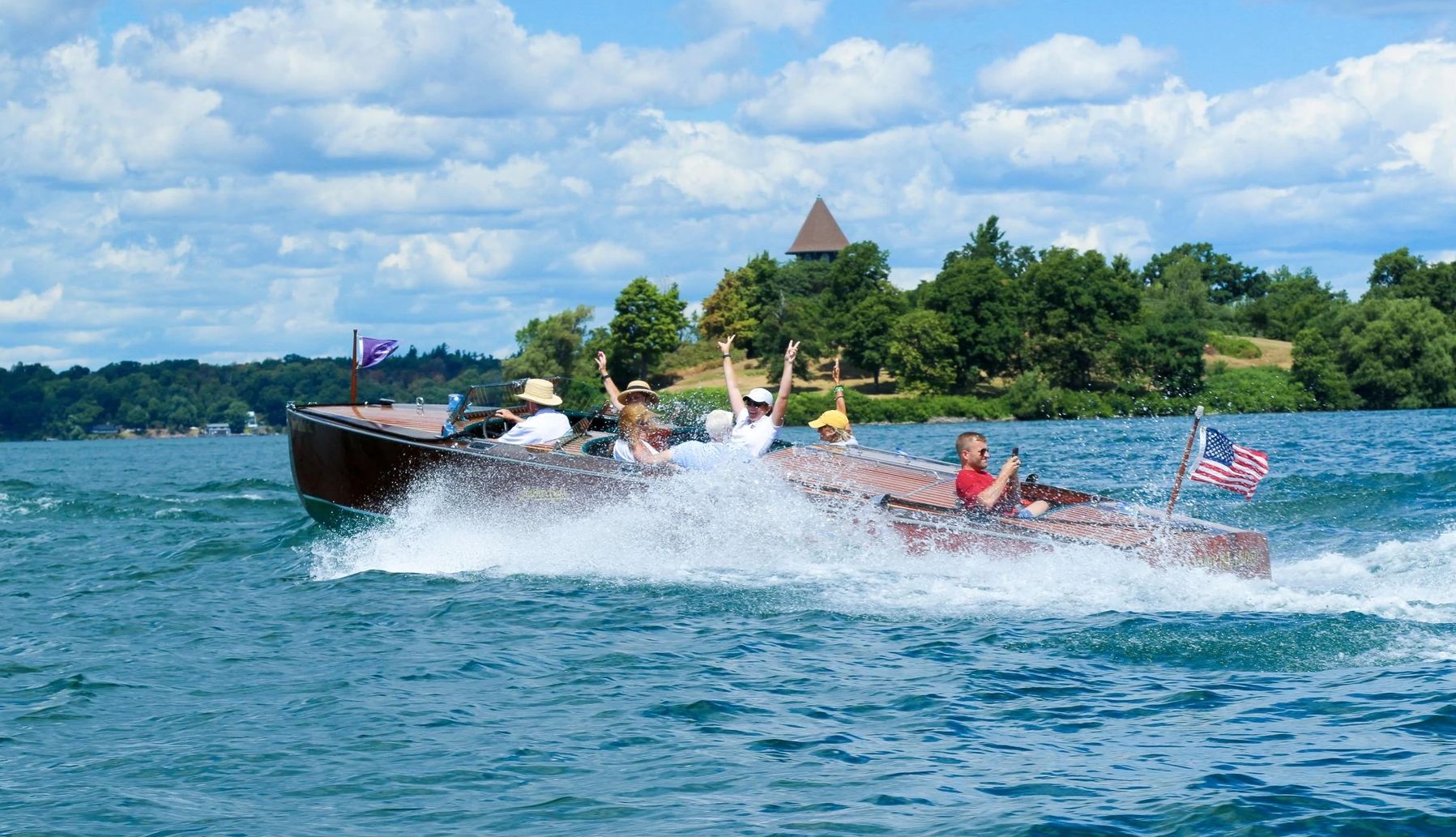 Great Lakes Getaways people riding in a speedboat on a lake