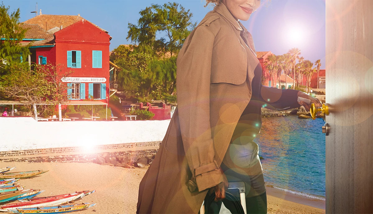 Woman stepping through a door from her work life to a beach in Senegal