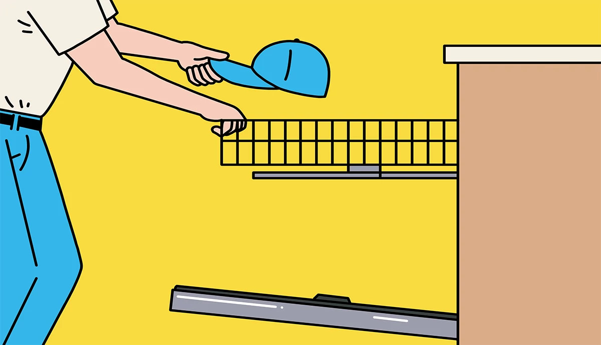 an illustration shows a man putting a baseball cap into a dishwasher