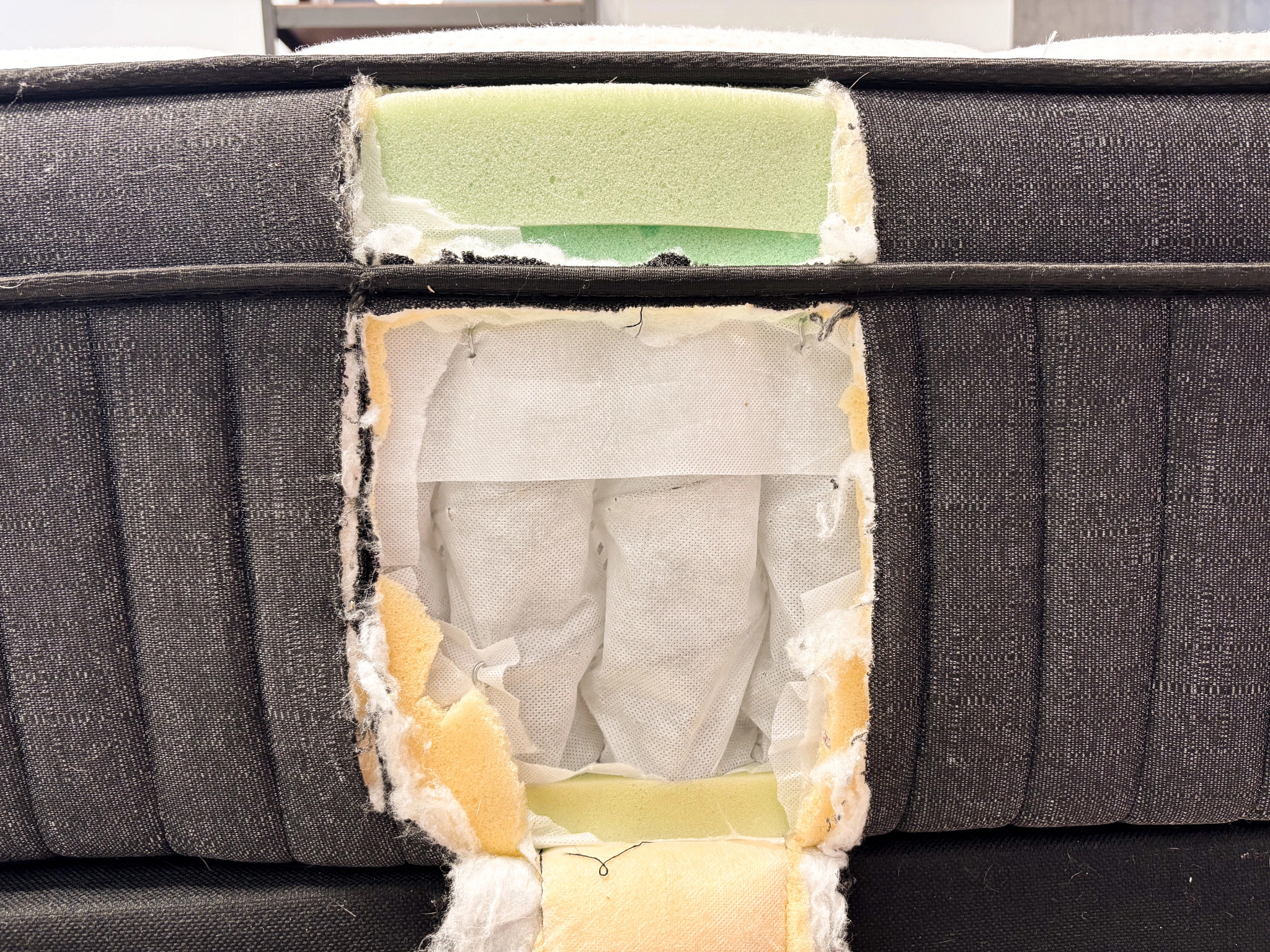 A mattress is cut open to reveal the coils wrapped in fabric inside