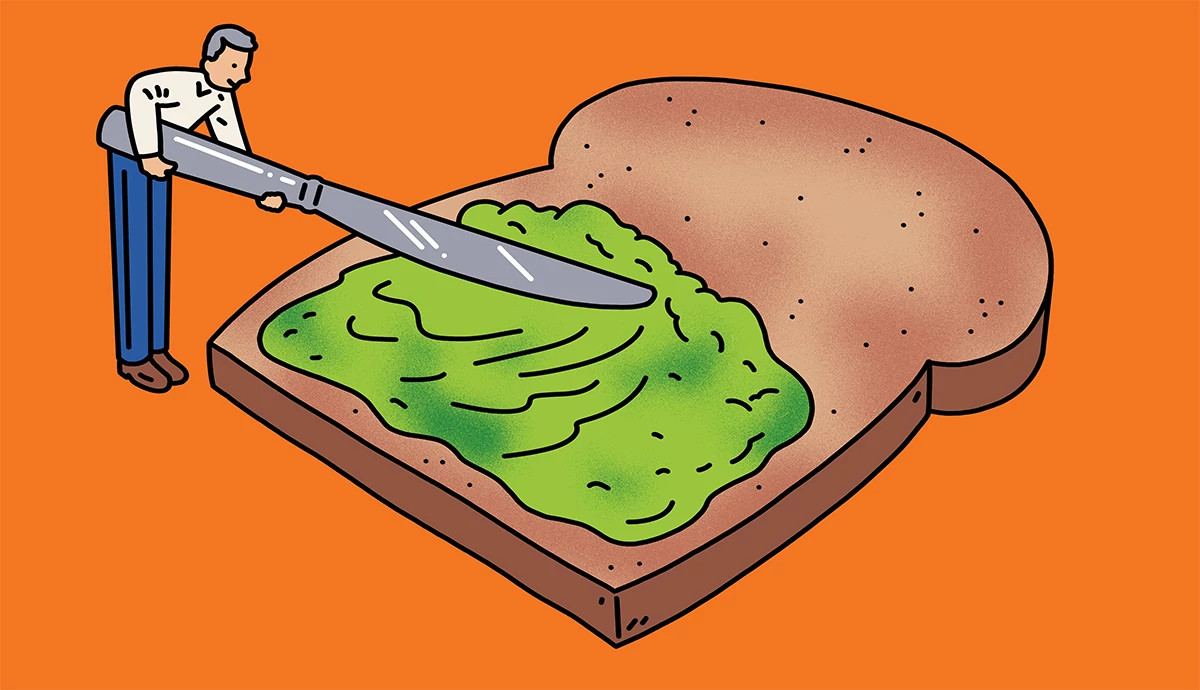 A whimsical illustration of a tiny man using an oversized butter knife to spread mashed green avocado onto a large slice of whole-grain toast against a solid orange background.