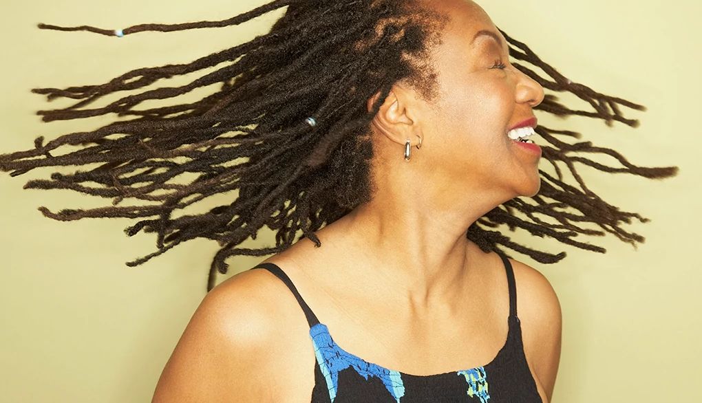 Dancing may help boost balance, coordination and cognitive function A woman smiling and swinging her hair in a studio