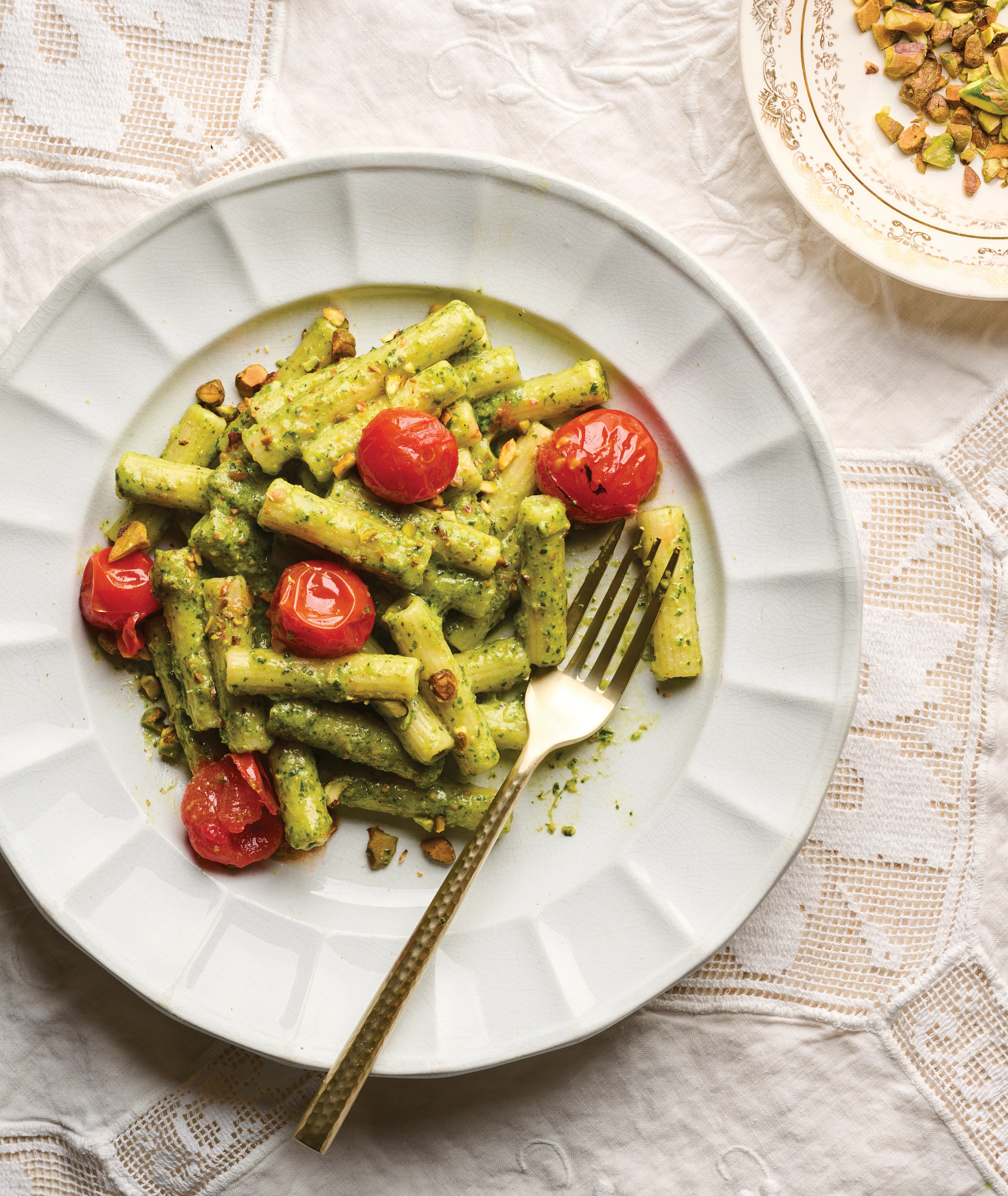 Giada De Laurentiis recipe ziti with pesto and tomatoes on a white plate