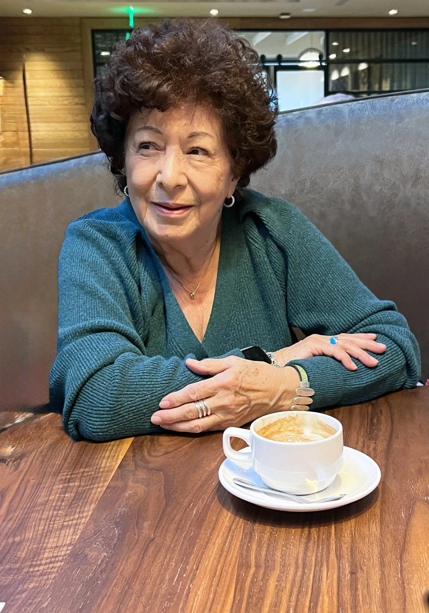 linda port seated at a table with a cappucino