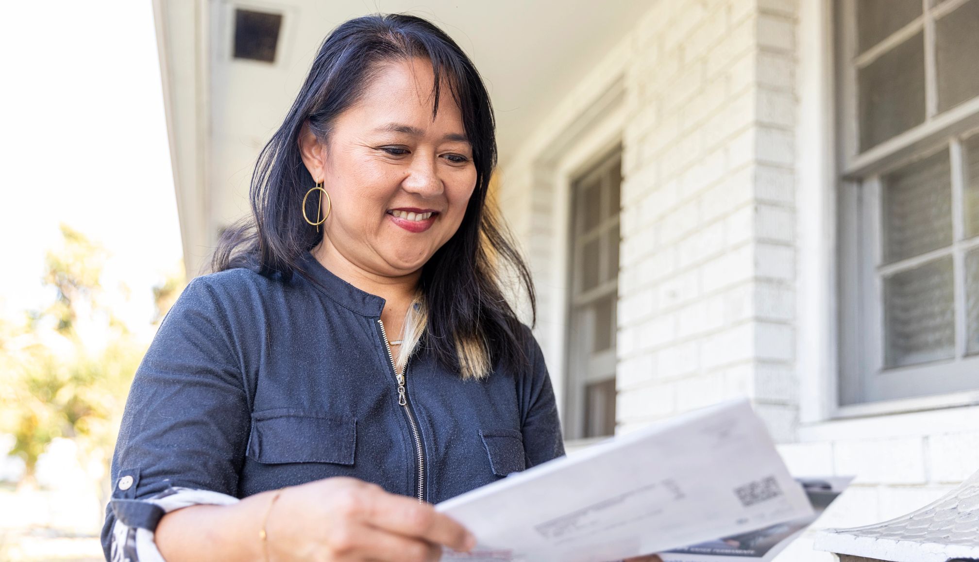 Are You Eligible for the Credit Repair Refund Checks? a woman looking at her mail