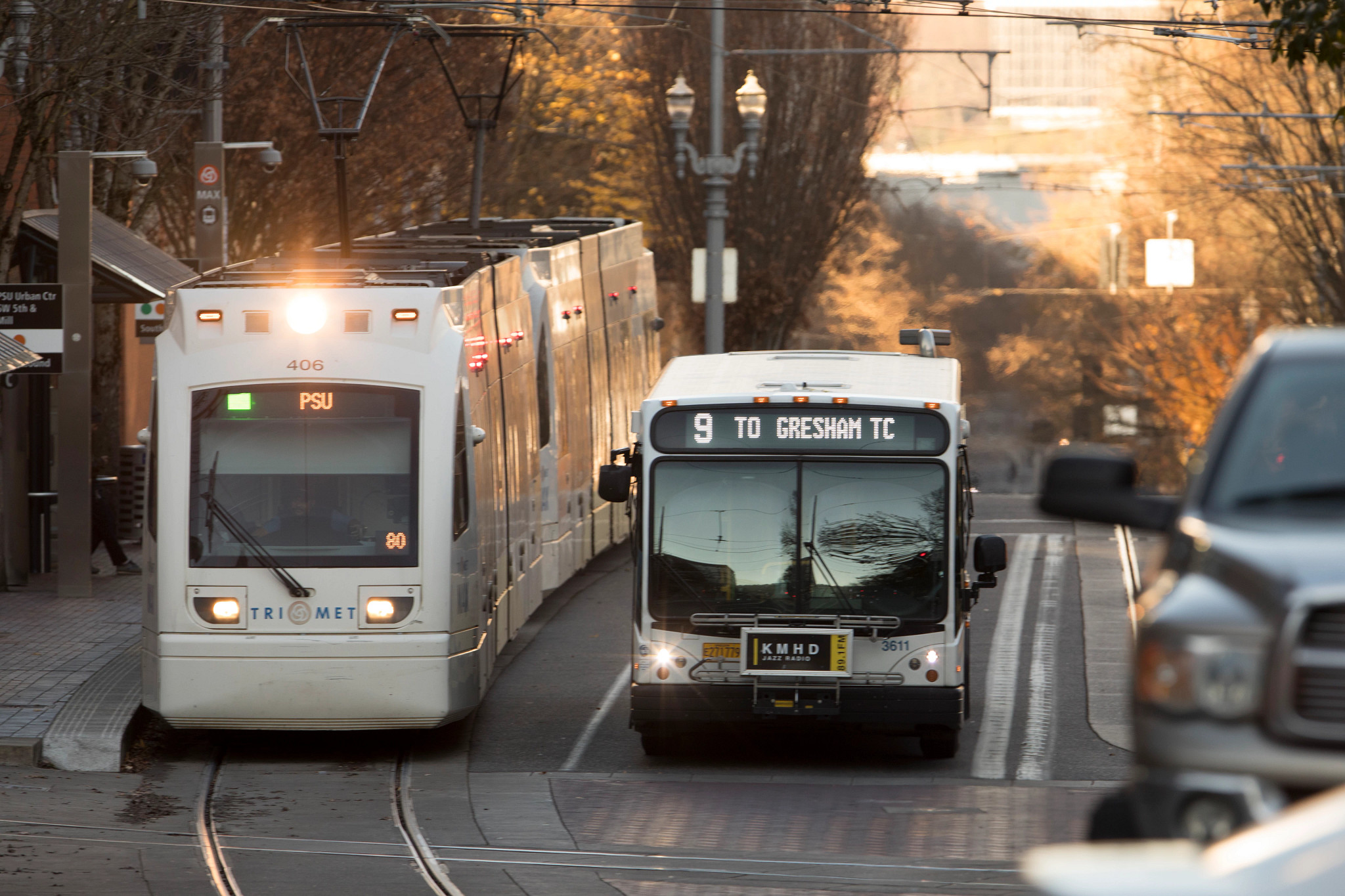 MAX train and bus in downtown Portland on routes to Portland State University and Gresham.