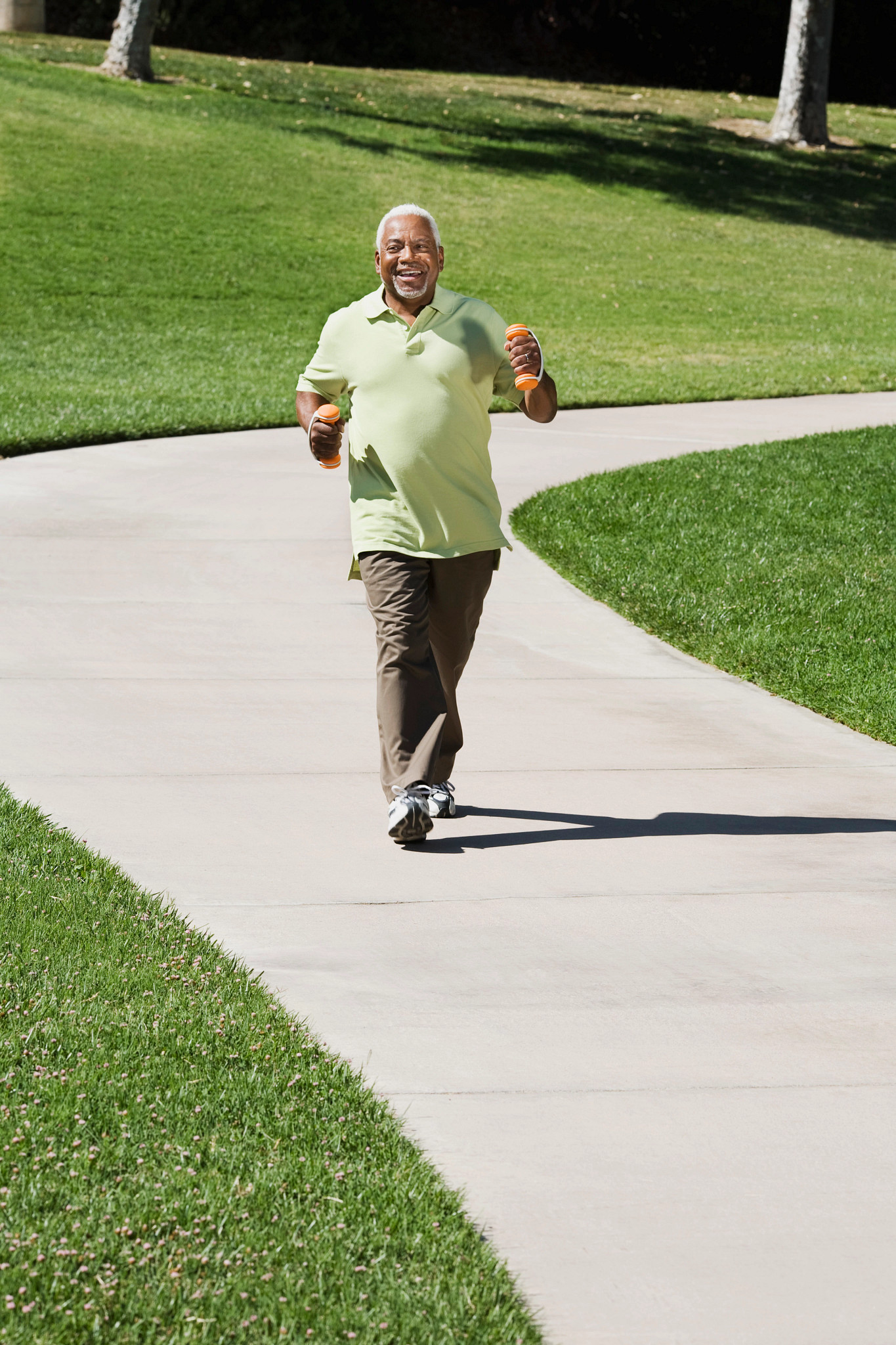 Senior man walking with weights