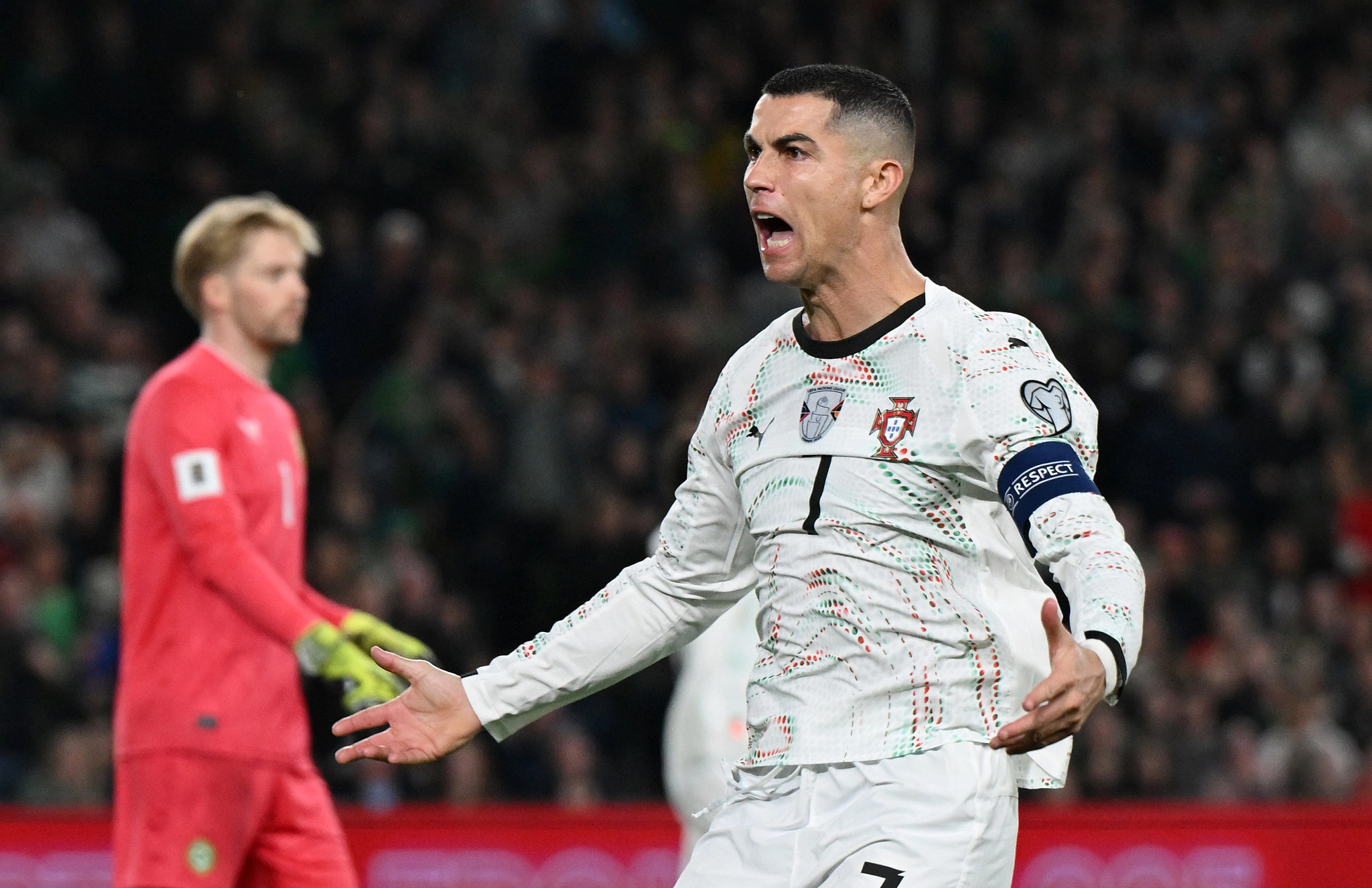 cristiano ronaldo shouting with arms outstretched during a soccer match