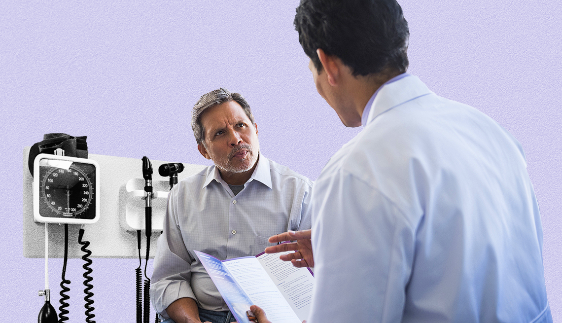 High blood pressure is sometimes undertreated in older adults. man talking with his doctor with a blood pressure machine visible behind him
