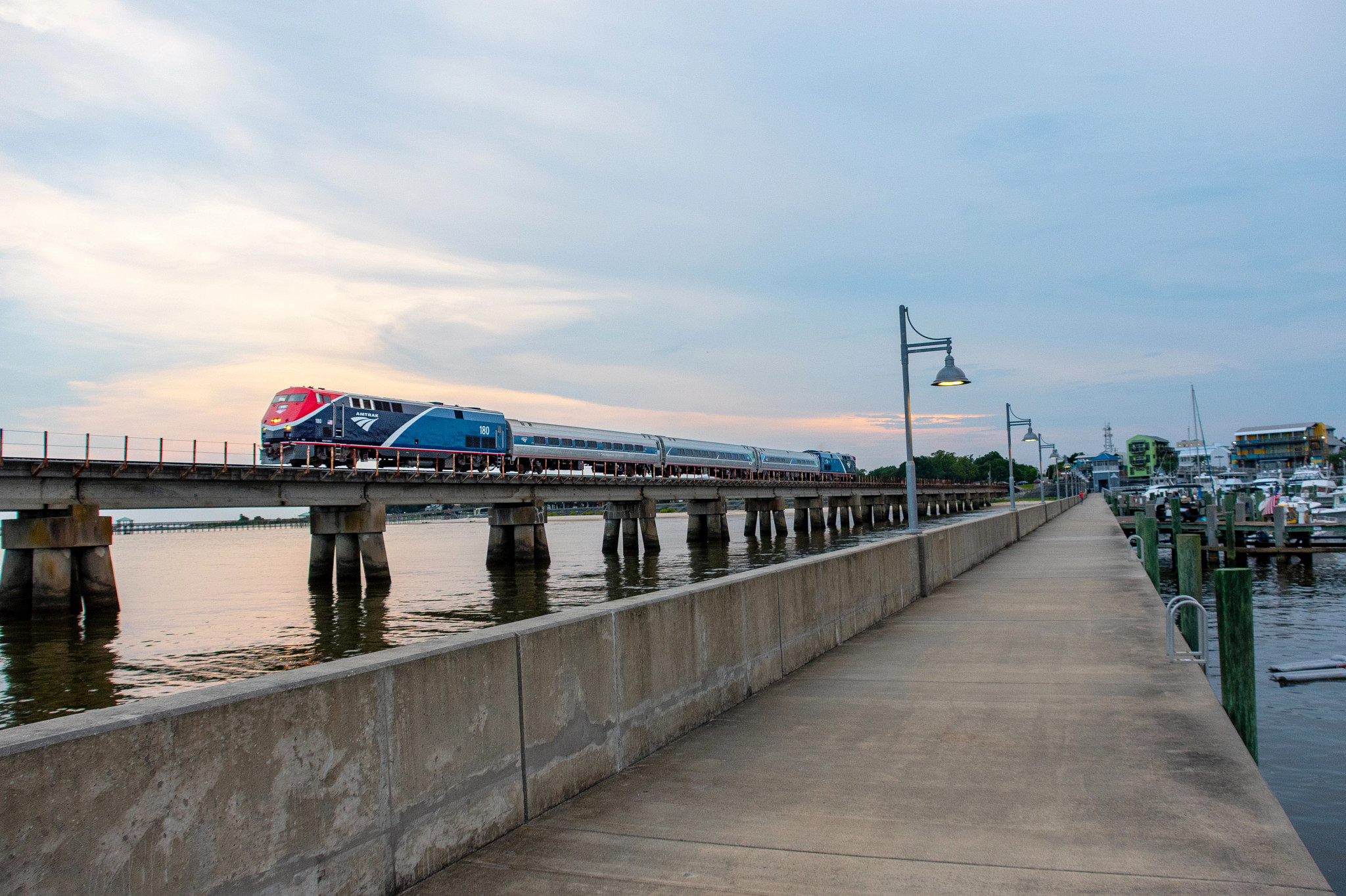an amtrak train traveling on a bridge