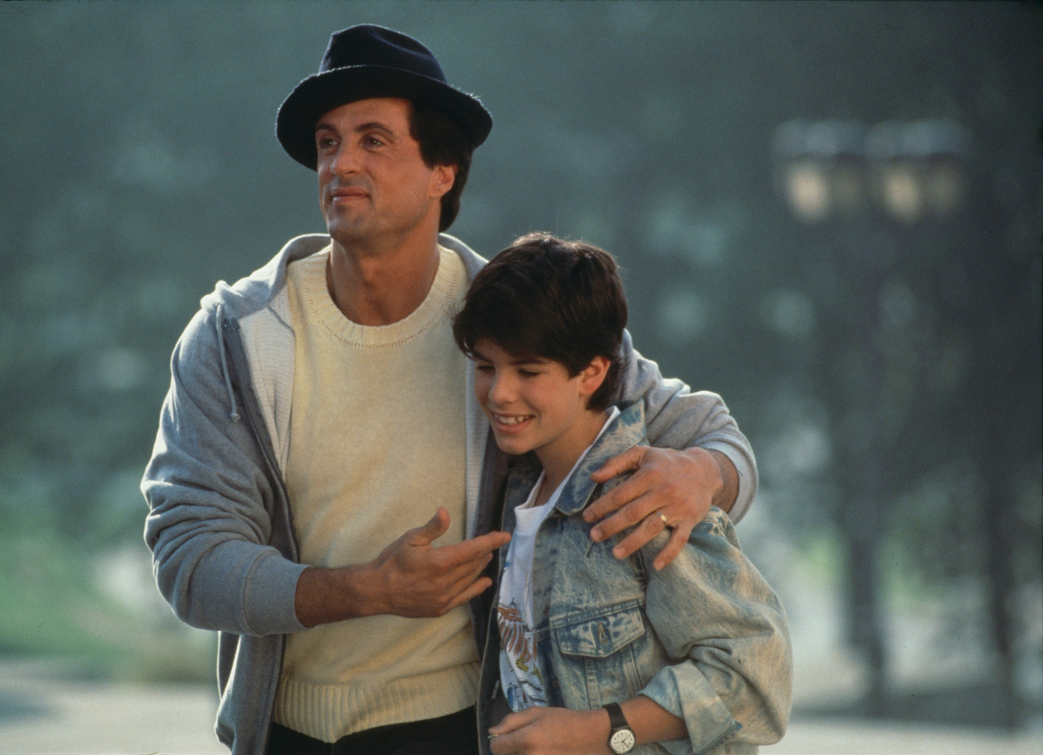 sylvester stallone with his arm around his son