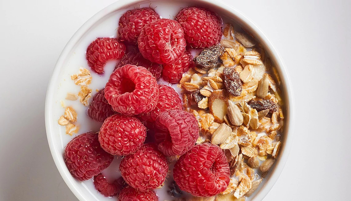 A close-up view of muesli with raspberries in a bowl