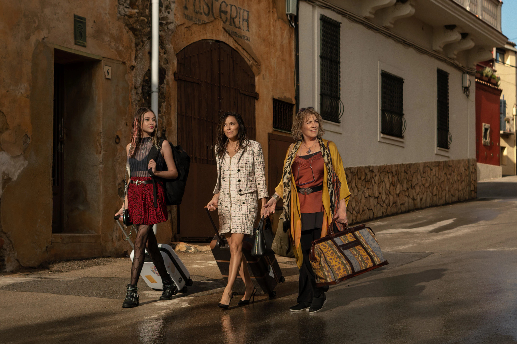 Eva Longoria walking down street with two other women in a still from Land of Women