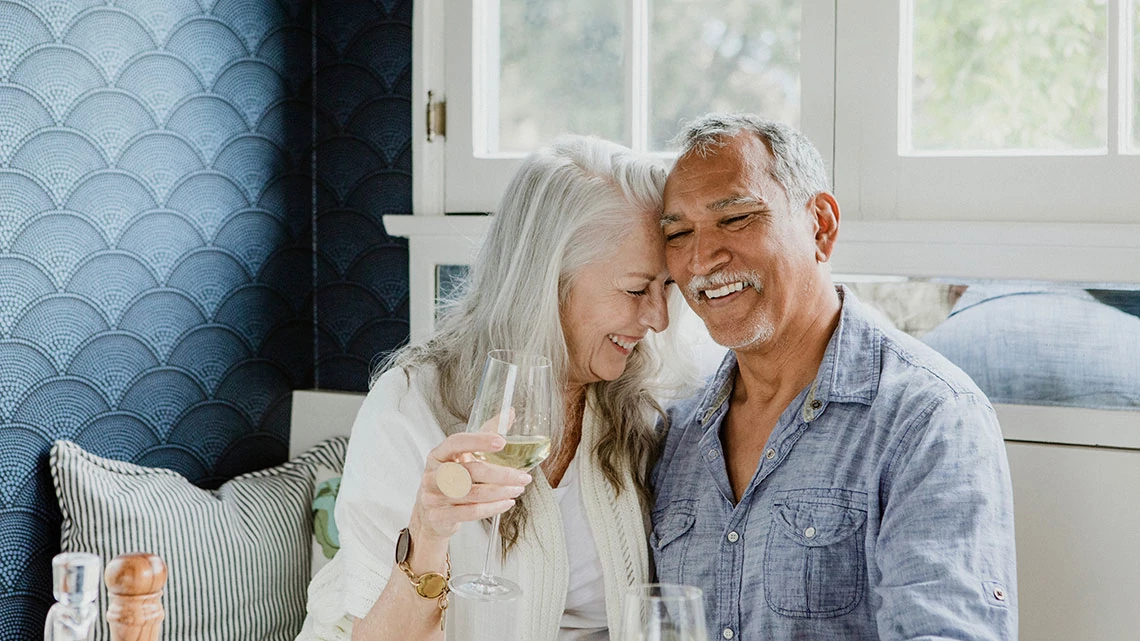 AARP Guaranteed Acceptance Life Insurance from New York Life Elderly couple having a white wine