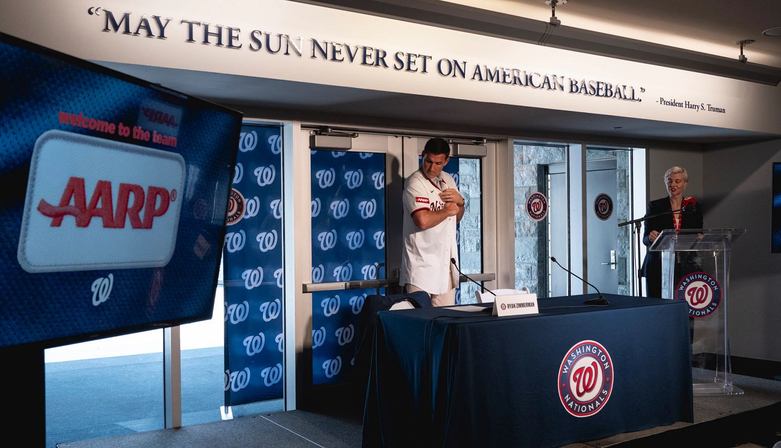 Washington Nationals and AARP Team Up ryan zimmerman showing the a a r p patch on the washington nationals jersey at a press conference