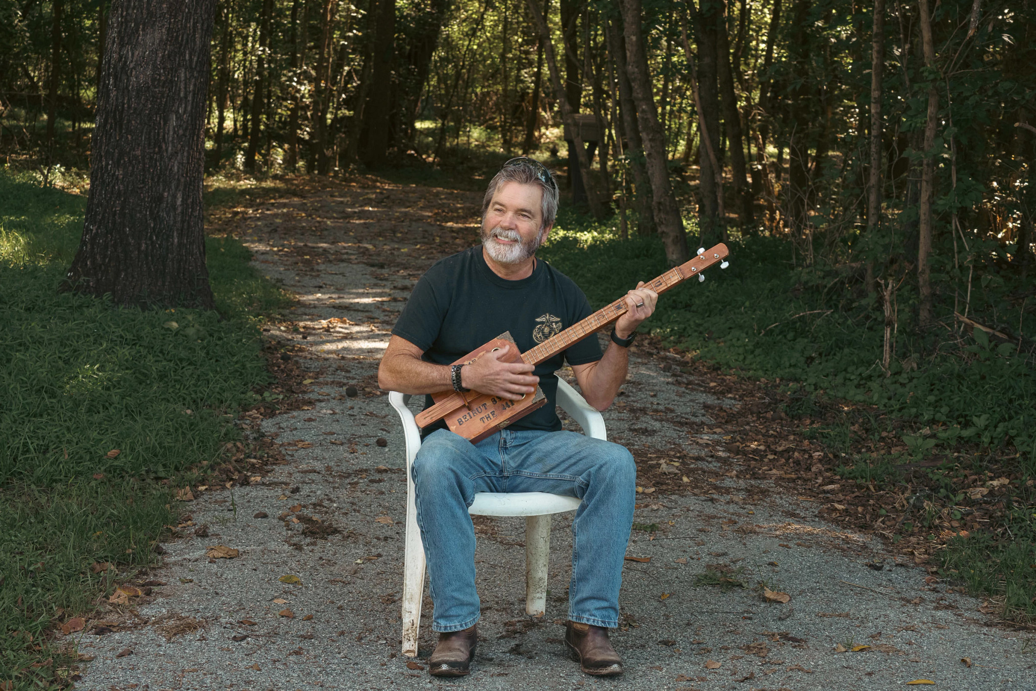 a man sitting down playing an instrument