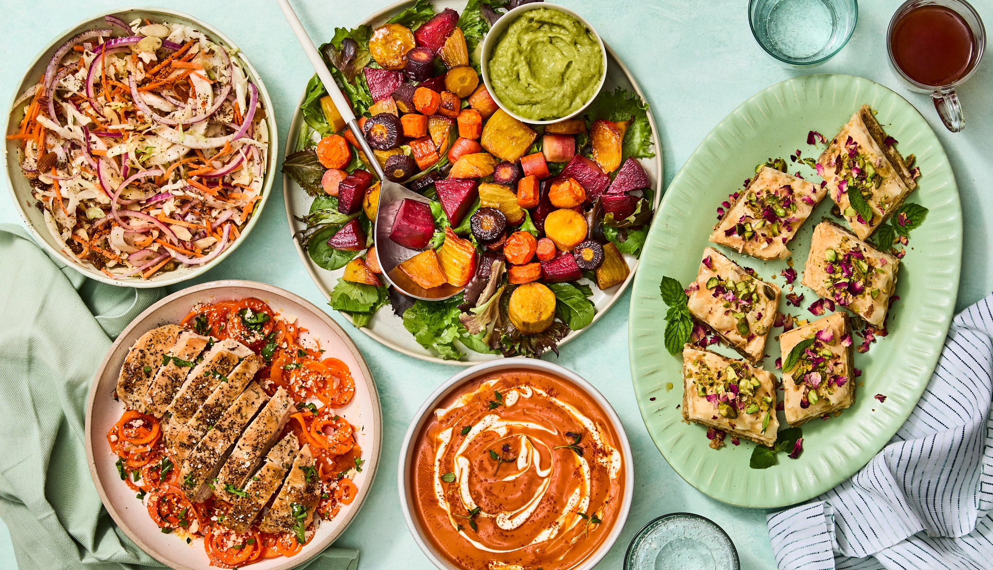 a photo shows carrot-fennel slaw; roasted root vegetables; carrot halwa; roasted carrot and tomato bisque; and carrot spiral bowls with garlic parmesan chicken
