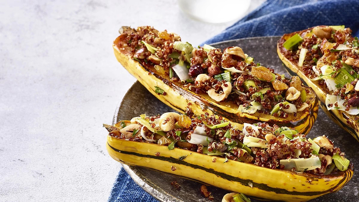 A close-up view of quinoa-stuffed delicata squash on a plate