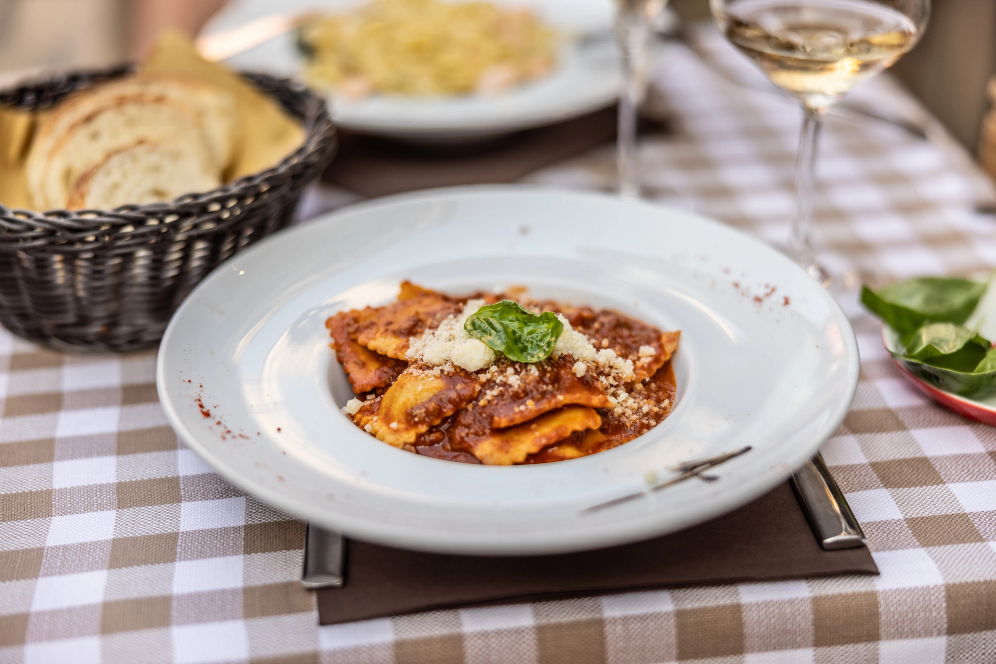 Italian pasta Ravioli in tomato sauce and olive oil on a restaurant terrace in Venice