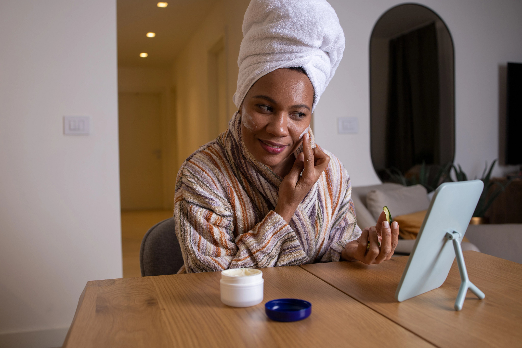 Woman applying cream on her face