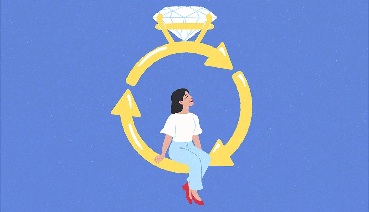 A woman sits on an engagement ring that resembles a recycling symbol of three arrows forming a circle.