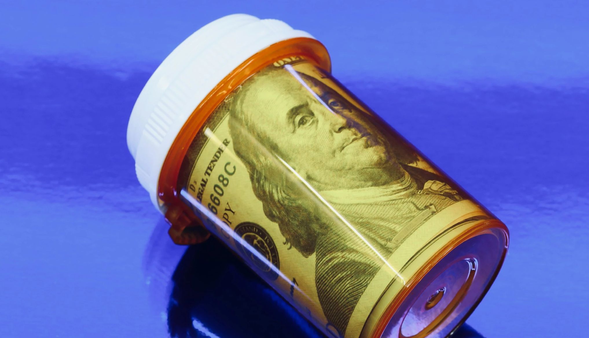 prescription bottle with a one hundred dollar bill inside