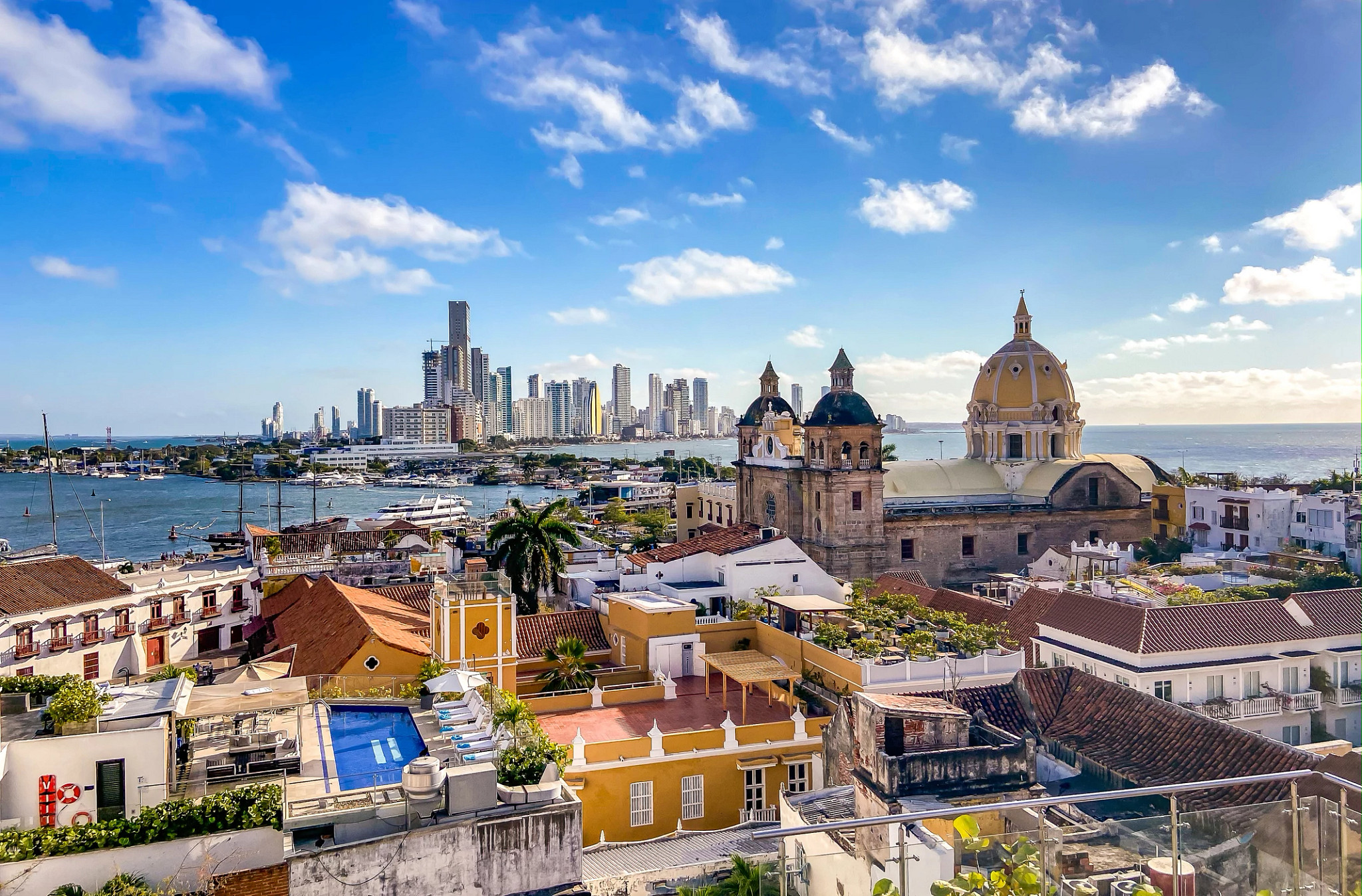 Aerial view of Cartagena, Colombia, with historic cathedral, waterfront, and river cruise ships docked in the harbor