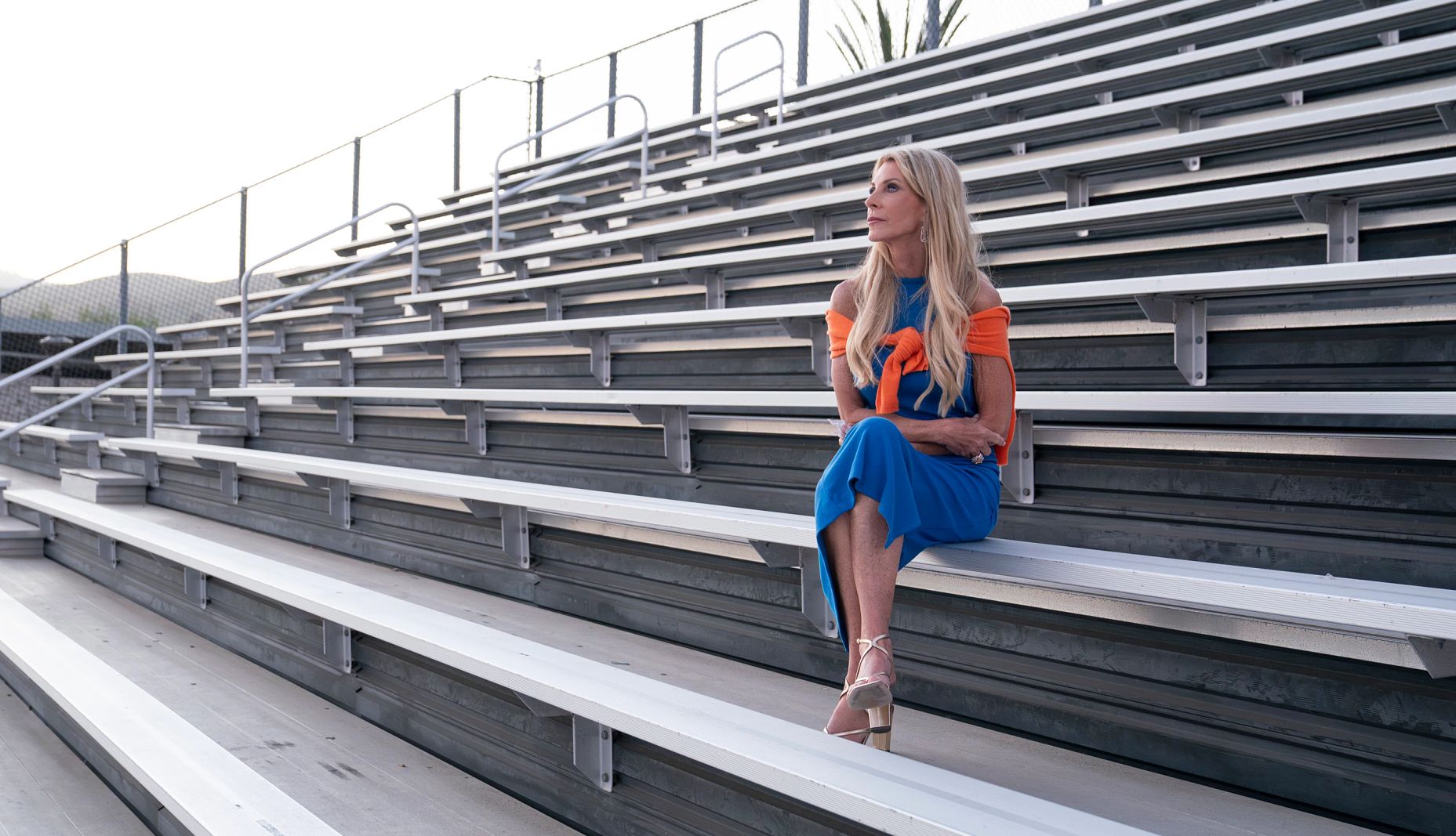 The Golden Bachelorette Joan Vassos The Golden Bachelorette Joan Vassos sitting in the bleachers at a field