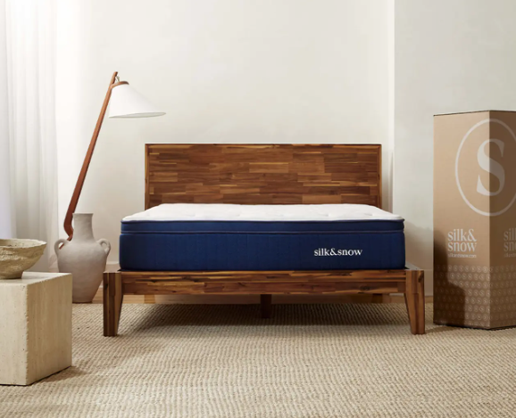 The Silk & Snow Hybrid mattress on a slatted wood bedframe.