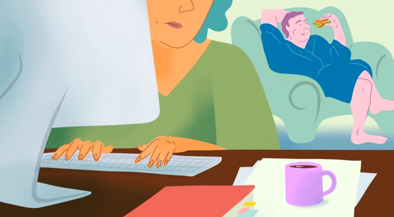 My Husband is Regressing in Retirement a woman types on a computer while a man in a robe eats a sandwich on the couch behind her