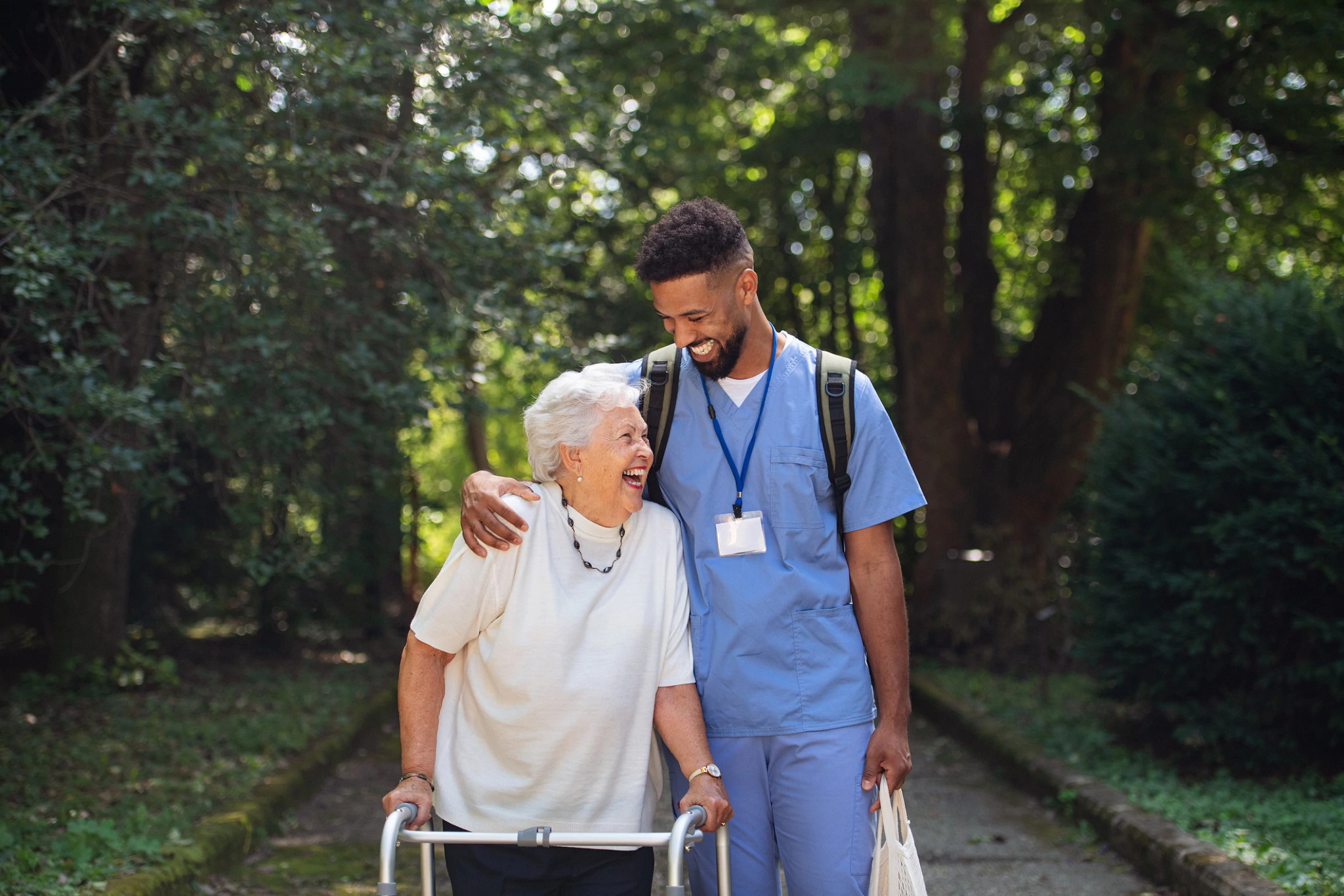 2 people outdoors one sitting in wheelchair