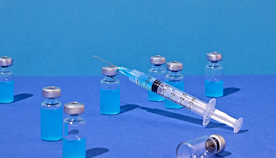 a syringe and several vials of blue liquid