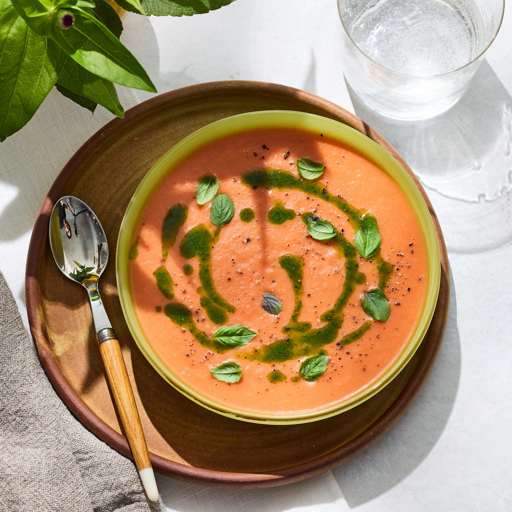 spicy stone fruit gazpacho with basil oil is pictured