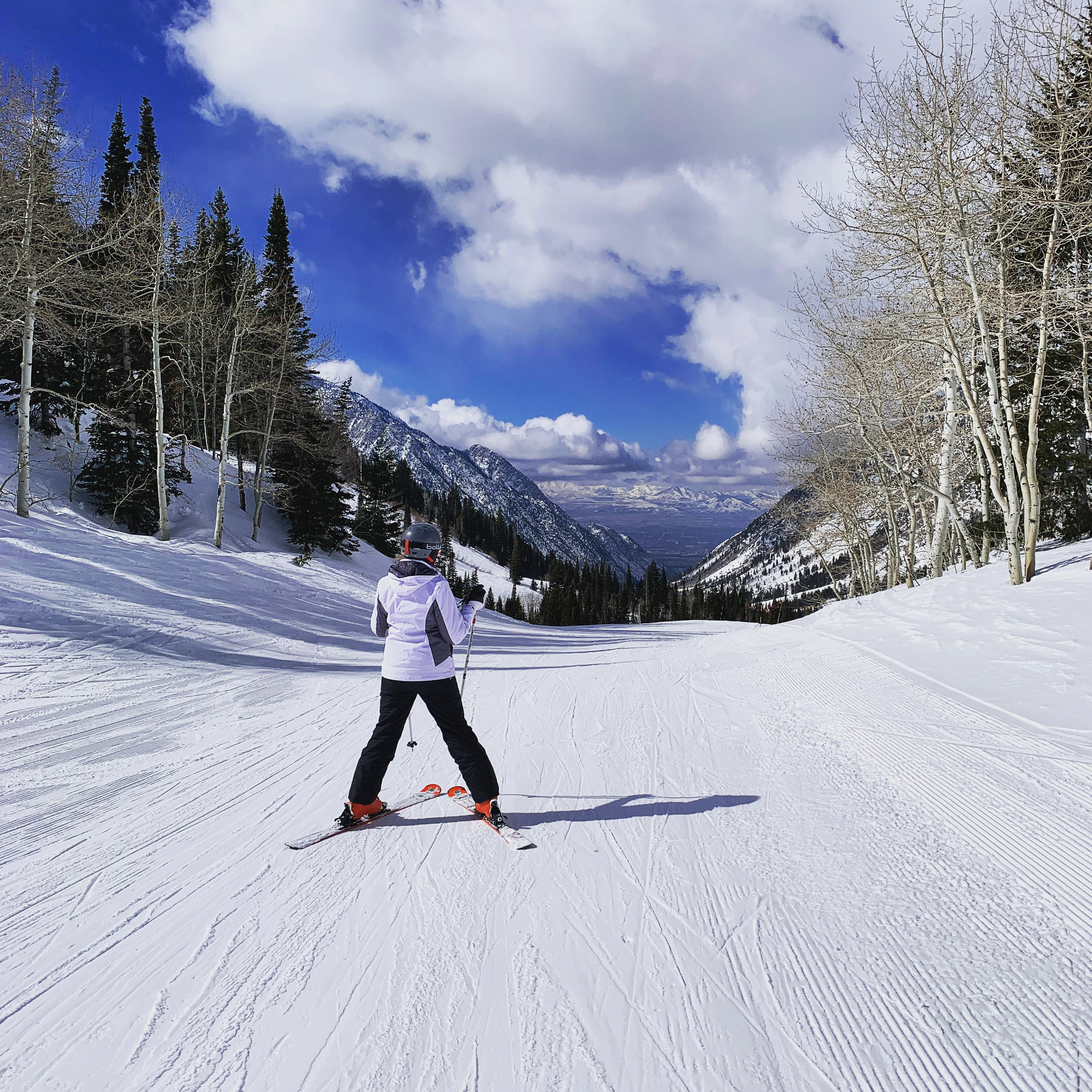 a skier showing shapes she learned at beginner lessons