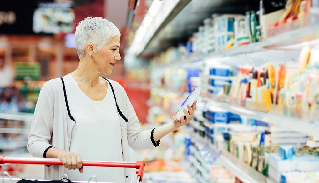 Taking a more mindful approach as you grocery shop can help you make healthier choices A woman grocery shopping with a cart at a store