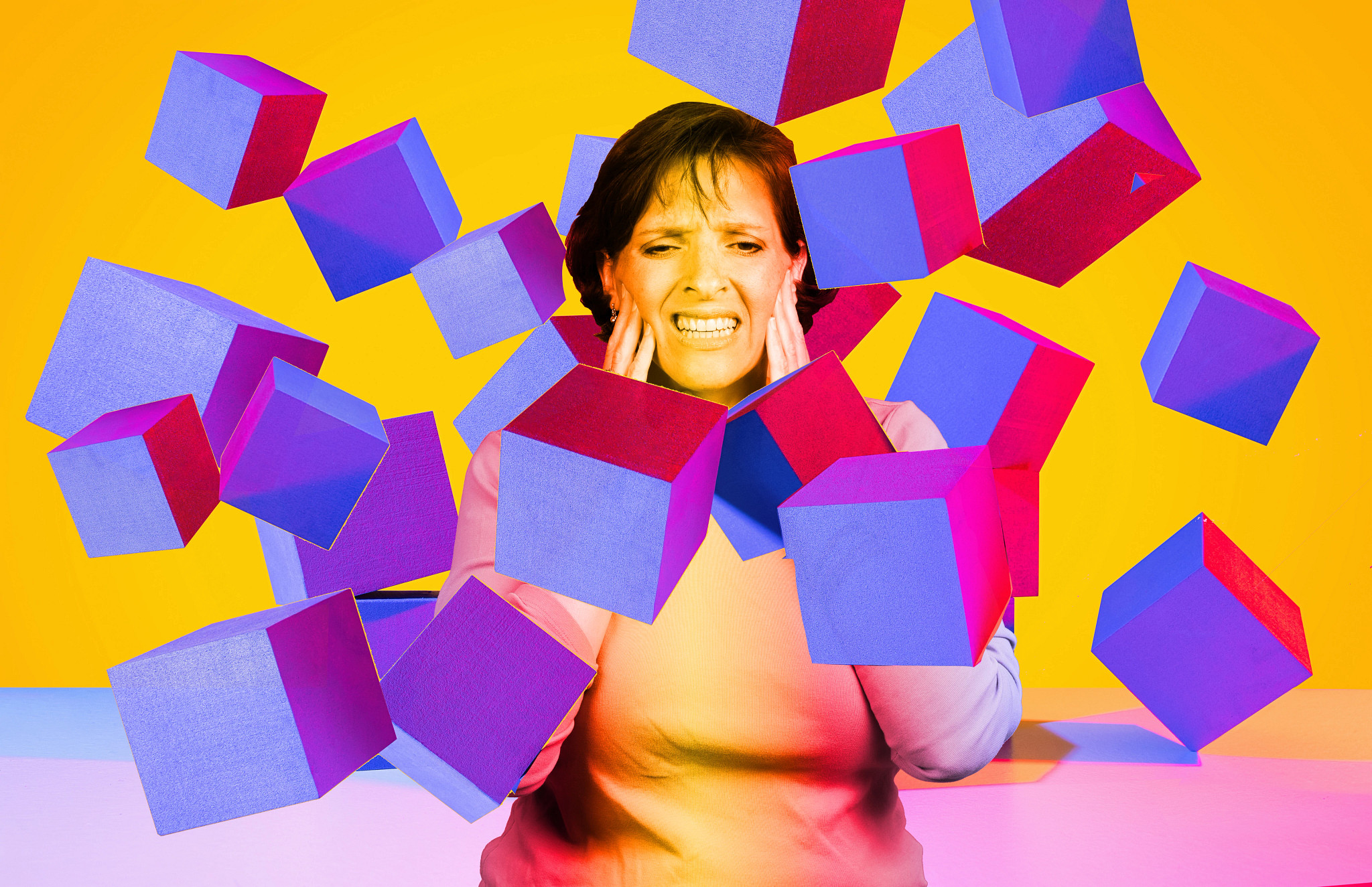 An anxious older woman holding her face as floating purple and red geometric cubes overwhelm the frame.